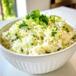 To make coconut lime rice, you need just a few simple ingredients. Here’s what you'll need: - 1 cup jasmine rice - 1 cup coconut milk - 1/2 cup water - 1 tablespoon lime juice - Zest of 1 lime - 1 tablespoon sugar (optional) - 1/4 teaspoon salt - Fresh cilantro or parsley for garnish Each ingredient plays an important role in creating the perfect flavor. Jasmine rice brings a light, floral note. Coconut milk adds creaminess and sweetness. Lime juice and zest bring a bright, tangy kick. Sugar is optional but can enhance the sweetness of the dish. Salt rounds out the flavors, while fresh herbs provide a burst of freshness. When you gather your ingredients, make sure they are fresh. This will ensure your coconut lime rice is as tasty as possible. Using high-quality coconut milk also makes a big difference in flavor and texture. Enjoy the process of cooking with these vibrant ingredients! - Rinsing Jasmine Rice First, rinse 1 cup of jasmine rice under cold water. Keep rinsing until the water runs clear. This step helps remove excess starch. Removing starch makes the rice fluffy and light. - Combining Ingredients in Saucepan In a medium saucepan, add the rinsed rice. Then, pour in 1 cup of coconut milk and 1/2 cup of water. Next, add 1 tablespoon of lime juice and the zest of 1 lime. If you like, stir in 1 tablespoon of sugar and 1/4 teaspoon of salt. Mix gently to combine everything. - Bringing to a Boil Place the saucepan over medium-high heat. Bring the mixture to a gentle boil. Watch it carefully to prevent it from boiling over. - Simmering for Tender Rice Once boiling, reduce the heat to low. Cover the saucepan with a lid. Let it simmer for about 18-20 minutes. The rice should become tender, and all the liquid should be absorbed. - Steaming the Rice After cooking, remove the saucepan from heat. Let it sit, still covered, for 5 minutes. This step helps steam the rice and makes it even fluffier. - Fluffing and Seasoning Use a fork to fluff the rice gently. Taste it to check if you need to adjust the seasoning. Finally, transfer the coconut lime rice to a serving dish. Garnish with fresh cilantro or parsley for a vibrant touch. - Importance of Rinsing Rice Rinsing jasmine rice is a key step. It removes excess starch. This helps the rice cook fluffy. Make sure to rinse until the water runs clear. - Adjusting Liquids for Different Textures You can change the liquid amounts for texture. For creamier rice, use more coconut milk. For drier rice, cut back on the liquid. Experiment to find your perfect balance. - Using Different Types of Rice Jasmine rice is great, but you can try others. Basmati or long-grain rice work well too. Each type brings a unique taste and texture. - Optional Ingredients for Extra Flavor For added flavor, consider a dash of soy sauce. You can also try adding coconut flakes or chopped nuts. These ingredients make the dish even more exciting. - Garnishing Ideas Garnish the rice with fresh cilantro or parsley. This adds color and freshness. You can also sprinkle some lime zest on top for extra zing. - Serving Suggestions for Different Occasions Coconut lime rice fits many meals. Serve it with grilled fish for a light dinner. It pairs well with chicken or as a base for a hearty bowl. {{image_2}} You can enhance your coconut lime rice by adding vegetables. Peppers or peas work great. Chop bell peppers into small pieces. Stir them into the rice during the last few minutes of cooking. This adds color and crunch. You can also mix in nuts for extra texture. Cashews or almonds are perfect choices. They bring a nice crunch. Toast the nuts lightly before adding them. This step boosts their flavor and makes the dish even better. If you like heat, try spicy coconut lime rice. Add chopped jalapeños to the pot. They infuse the rice with a nice kick. If you prefer, sprinkle in red pepper flakes. Start with a small amount and taste as you go. Adjust the lime to make it zesty. More lime juice adds brightness. Just be careful not to overpower the coconut flavor. Balance is key for a tasty dish. Coconut lime rice pairs well with grilled fish or chicken. The creamy flavor complements the meat. Serve it alongside your protein for a complete meal. You can also use coconut lime rice as a base for bowls. Add your favorite toppings like grilled veggies or beans. This makes for a fun and filling dish. Mix and match to create your perfect bowl. To keep your coconut lime rice fresh, store it in an airtight container. Let it cool first before sealing. This step prevents moisture build-up. How Long Does It Last? In the fridge, coconut lime rice lasts about 3 to 4 days. Always check for any off smells before eating. Techniques for Maintaining Texture When you reheat, you want to keep the rice fluffy. Add a splash of water to the rice. This helps steam it back to life. Microwave vs. Stove Reheating For the microwave, heat in short bursts. Stir in between to ensure even warming. If using the stove, add a little water. Warm it over low heat while stirring gently. Steps to Freeze Properly To freeze, let the rice cool completely. Then, place it in a freezer bag. Squeeze out the air and seal tightly. How to Thaw and Reheat To thaw, move the rice to the fridge overnight. Reheat as described earlier. Adding a bit of water will help regain its fluffy texture. Jasmine rice is the best choice for Coconut Lime Rice. It has a nice aroma and a slightly sweet taste. This rice cooks up fluffy and pairs well with coconut milk. You can also use basmati rice, but jasmine rice adds the best flavor. Yes, you can make this recipe vegan easily. The main ingredients are already plant-based. Just ensure that your sugar is vegan, as some sugars are processed with animal products. Use coconut milk, lime juice, and rice, and you have a great vegan dish! To adjust the recipe, simply multiply or divide the ingredients. If you want to serve more people, double the ingredients. For fewer servings, cut them in half. Remember to keep the same cooking method and time for best results. Yes, Coconut Lime Rice is gluten-free. The main ingredients—rice, coconut milk, and lime—contain no gluten. It’s a perfect side dish for anyone with gluten sensitivities. Always check your ingredient labels to be safe. You can use light coconut milk, but the rice may taste less creamy. Full-fat coconut milk gives a richer flavor and creamier texture. If you prefer a lighter dish, light coconut milk works fine. Just keep in mind the taste may change slightly. This article covers the delightful aspects of Coconut Lime Rice. You learned about key ingredients, detailed steps, and helpful tips. I shared variations to suit your taste and ideas for serving. Try the simple recipe to enjoy a tasty dish. Remember, experimenting with ingredients can enhance the flavor. Don't hesitate to make it your own! With the right storage, you can enjoy leftovers too. Dive into this dish and impress your family or friends.