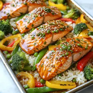 - 4 salmon fillets - 1 cup broccoli florets - 1 cup bell peppers, sliced (red and yellow) - 1 cup snap peas - 1/4 cup soy sauce (low sodium) - 2 tablespoons honey - 2 tablespoons rice vinegar - 1 tablespoon sesame oil - 2 cloves garlic, minced - 1 teaspoon ginger, grated - 1 tablespoon sesame seeds - Salt and pepper to taste - Cooked jasmine rice, for serving To make this dish shine, I use fresh salmon fillets. They bring a rich flavor that pairs well with the teriyaki sauce. I love adding bright veggies like broccoli, bell peppers, and snap peas. They not only taste great but also make the plate look colorful. The teriyaki marinade is simple yet powerful. It combines soy sauce, honey, rice vinegar, sesame oil, minced garlic, and grated ginger. Each ingredient adds a unique flavor that makes the salmon taste amazing. Don’t forget the sesame seeds! They add a nice crunch and look great on the dish. Sprinkling salt and pepper enhances all the flavors. Finally, serve the salmon over jasmine rice. This way, the rice soaks up the delicious sauce. Enjoy! {{ingredient_image_1}} - Preheat the oven to 400°F (200°C). - Line a large baking sheet with parchment paper. This makes cleanup easy. - In a small bowl, whisk together: - 1/4 cup soy sauce (low sodium) - 2 tablespoons honey - 2 tablespoons rice vinegar - 1 tablespoon sesame oil - 2 cloves garlic, minced - 1 teaspoon ginger, grated This marinade adds a sweet and savory touch to the salmon. - Place 4 salmon fillets on one side of the baking sheet. - Season them with salt and pepper to taste. - Pour half the teriyaki marinade over the salmon. Make sure they are well coated. - In another bowl, toss: - 1 cup broccoli florets - 1 cup sliced bell peppers (red and yellow) - 1 cup snap peas - Coat the veggies with the remaining marinade. Arrange them on the other side of the baking sheet. - Sprinkle 1 tablespoon sesame seeds over the salmon and vegetables. - Bake in the preheated oven for 15-20 minutes. - Check for doneness. The salmon should flake easily with a fork, and the veggies should be tender yet crisp. This simple process leads to a delicious meal! - Use fresh salmon for the best flavor. Fresh salmon tastes better and cooks well. - A meat thermometer helps check doneness. Salmon is perfect at 145°F (63°C). - You can customize the marinade. Add spices like red pepper flakes for heat. - Marinate the salmon for extra flavor. If you have time, let it sit for 30 minutes. - Serve the salmon with jasmine rice to soak up the sauce. - Add colorful veggies to the plate for a nice look. - Drizzle extra marinade over the dish for more flavor. Pro Tips Marinade Time: For enhanced flavor, let the salmon marinate for at least 30 minutes, or up to 2 hours in the refrigerator before baking. Vegetable Variations: Feel free to mix and match your favorite veggies, such as carrots, zucchini, or asparagus, to add variety and nutrition to the dish. Perfectly Cooked Salmon: Use a meat thermometer to ensure the salmon reaches an internal temperature of 145°F (63°C) for optimal doneness. Serving Suggestions: Add a sprinkle of chopped green onions or a squeeze of lime juice right before serving for an extra burst of flavor. {{image_2}} You can switch the broccoli, bell peppers, and snap peas with other tasty veggies. Try using zucchini, carrots, or asparagus for a new flavor. Seasonal veggies like green beans in spring or squash in fall add freshness. Mixing colors makes your dish more appealing and fun. If you prefer chicken or tofu, you can easily swap them for salmon. For chicken, use boneless, skinless breasts. Cook them for about 20-25 minutes. If you choose tofu, press it to remove extra water. Cut it into cubes and bake for 15-20 minutes. Adjust the marinade to soak in more flavor. To heat things up, add spices or chili flakes to the marinade. You can also toss in fresh herbs like cilantro or basil for a bright taste. A squeeze of lime or lemon juice adds a zesty punch. These small changes can make your meal feel completely new. To store leftovers, first let the salmon and veggies cool. Place them in an airtight container. Keep it in the fridge for up to three days. When you reheat salmon, use low heat to keep it moist. A microwave works well; just cover it with a damp paper towel. You can also use an oven at 300°F (150°C) for about ten minutes. This helps keep the fish flaky. You can freeze leftover teriyaki salmon. Wrap each piece tightly in plastic wrap, then place it in a freezer bag. This helps prevent freezer burn. For the veggies, store them in a separate bag. They freeze well for up to three months. To thaw, move the salmon to the fridge overnight. You can reheat it in the oven or microwave, just like before. Stored salmon and vegetables last about three days in the fridge. After that, the quality may drop. Check for off smells or slimy textures. If you see any of these signs, it's best to throw it away. Proper storage keeps your meal fresh and safe to eat. Cooking teriyaki salmon takes about 15 to 20 minutes. The oven should be set to 400°F (200°C). Factors like thickness of the salmon and oven type can change the time slightly. Always check if the salmon flakes easily with a fork. This shows it is done. Yes, you can prep this meal ahead. Marinade the salmon in the teriyaki sauce for extra flavor. You can chop the veggies and store them in the fridge. This way, you save time on busy days. Just bake everything when you are ready to eat. If you need a rice substitute, try brown rice or quinoa. Both add a nutty taste and are healthy. You could also use cauliflower rice for a low-carb option. Each of these sides pairs well with the teriyaki flavors. This recipe offers a simple way to enjoy teriyaki salmon with fresh veggies. We covered main ingredients, step-by-step cooking, and tips for perfect results. Remember, you can customize the dish with different proteins and veggies. With proper storage, leftovers can be just as tasty. So, get ready to impress family and friends with this healthy and flavorful meal. Enjoy your cooking journey, and savor every bite!